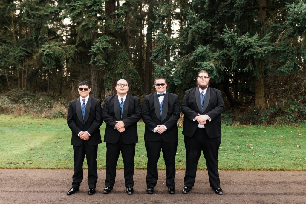 groomsmen stand left hand over right