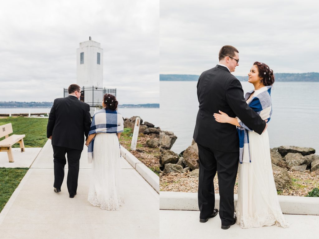 behind capture of bride and groom walking towards lighthouse