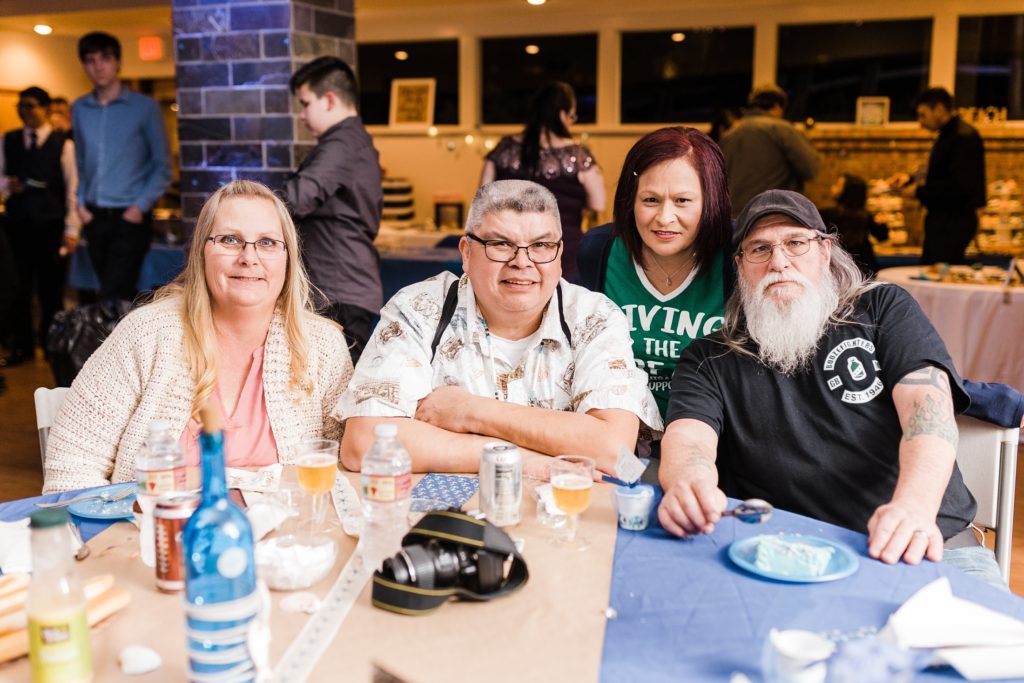 Family members relaxing at a venue table