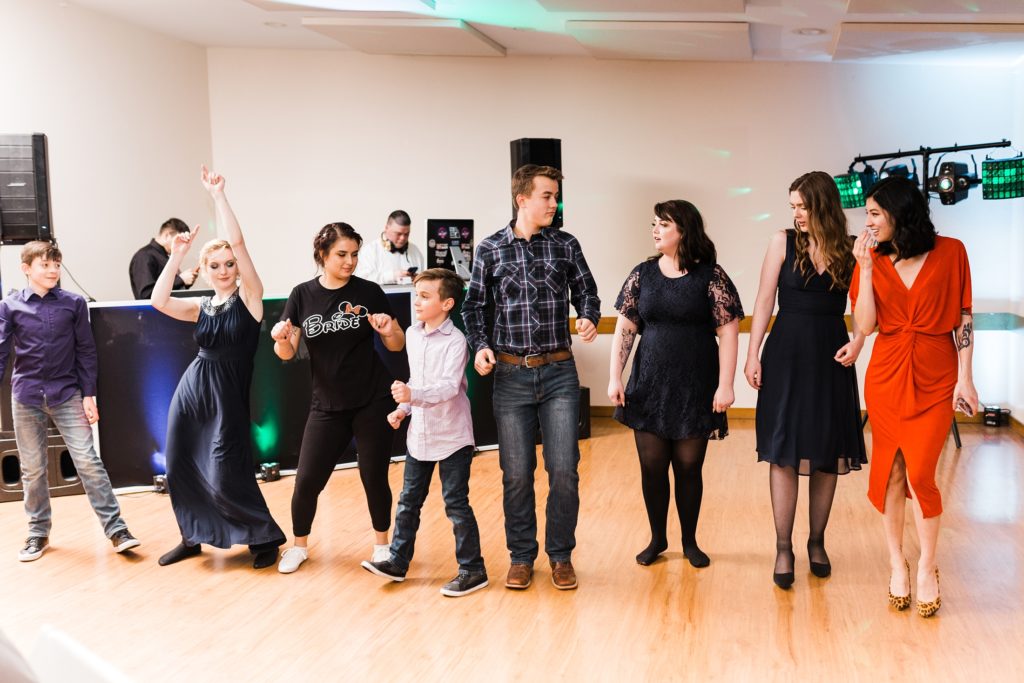 Guests lined up dancing at wedding reception