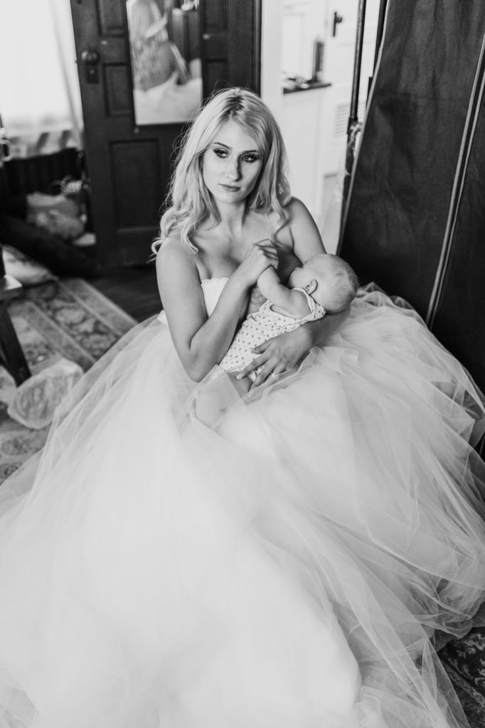 Bride looks toward light as baby eats