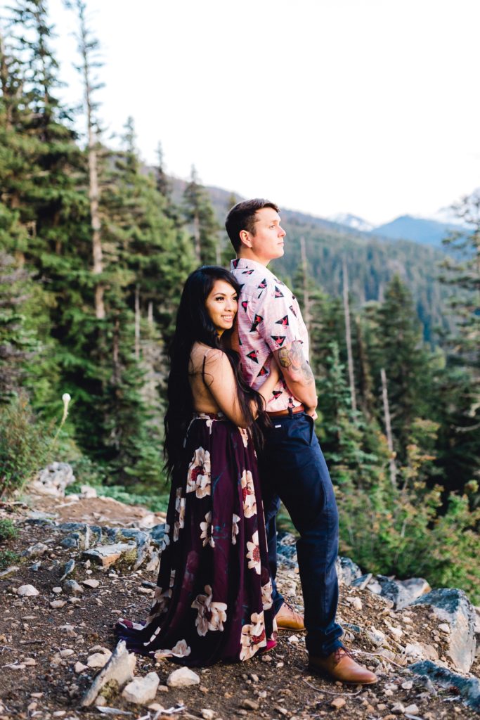 Woman hugs man from behind while taking in the view of Mt. Rainier